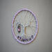 front view purple owl charm adorned tree of life wrapped in lavender color yarn